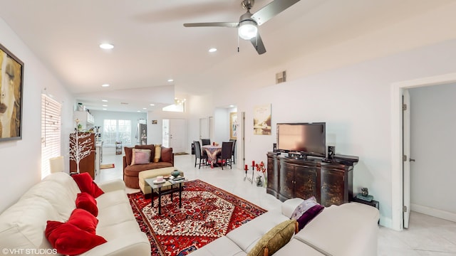 living area featuring lofted ceiling, light tile patterned floors, recessed lighting, visible vents, and baseboards