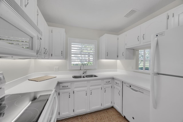 kitchen featuring white appliances, sink, and white cabinets