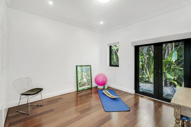 exercise area with crown molding, french doors, and hardwood / wood-style floors