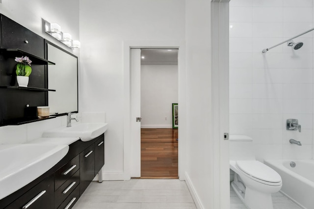 full bathroom featuring toilet, vanity, tiled shower / bath, and hardwood / wood-style floors