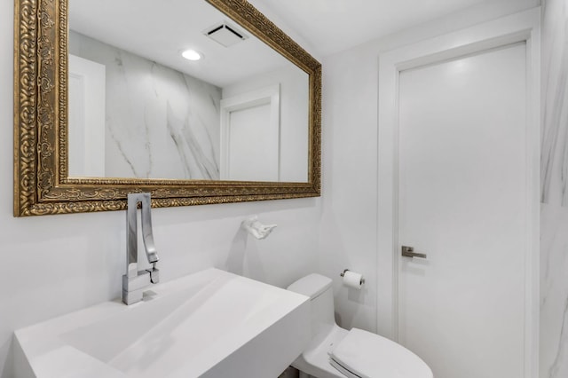 bathroom with sink and toilet