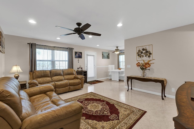 living room featuring a healthy amount of sunlight, light tile patterned floors, and ceiling fan