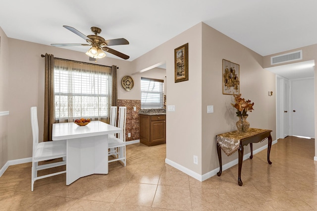 dining area with light tile patterned flooring and ceiling fan