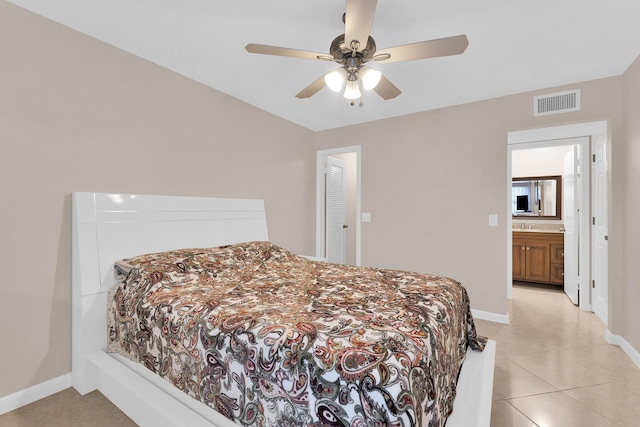 tiled bedroom featuring connected bathroom, sink, and ceiling fan