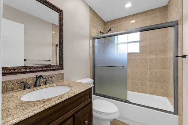 full bathroom with vanity, shower / bath combination with glass door, and toilet