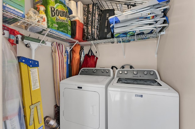 clothes washing area with washer and clothes dryer