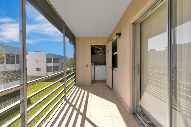 balcony with washing machine and clothes dryer