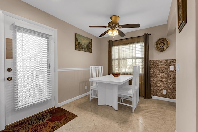 tiled dining room featuring ceiling fan