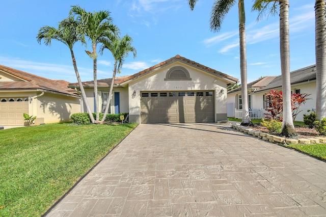 view of front of house with a garage and a front yard