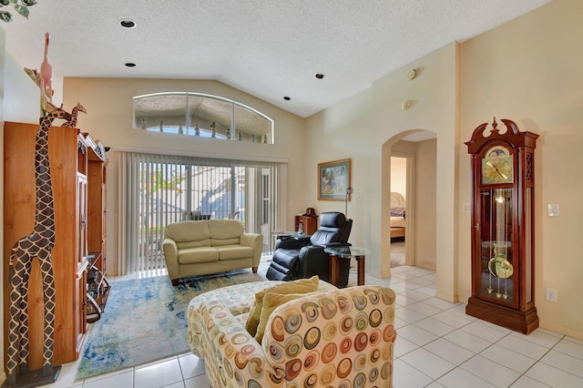 tiled living room with lofted ceiling and a textured ceiling