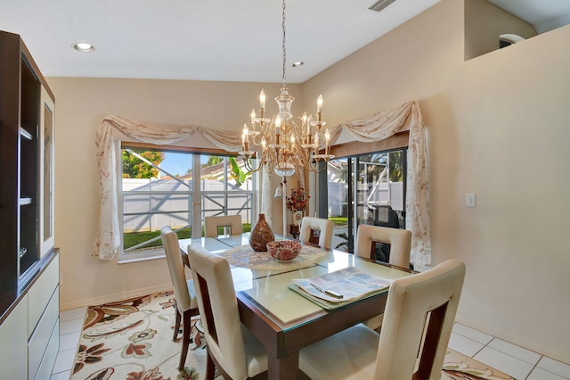 dining area featuring light tile patterned flooring and an inviting chandelier