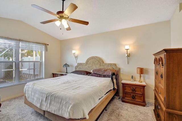 carpeted bedroom featuring vaulted ceiling and ceiling fan