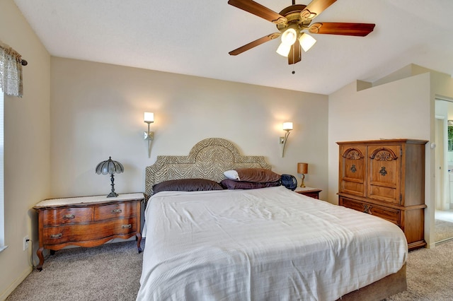 carpeted bedroom featuring vaulted ceiling and ceiling fan