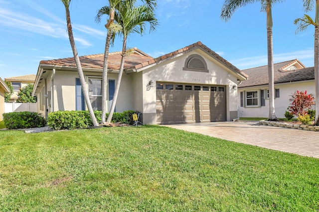 view of front of home featuring a garage and a front yard