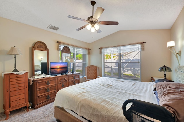 bedroom with vaulted ceiling, light colored carpet, and ceiling fan