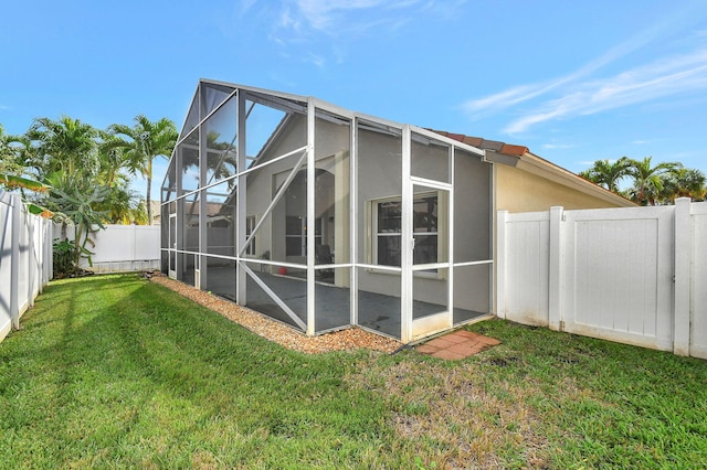 view of property exterior with a lanai and a lawn