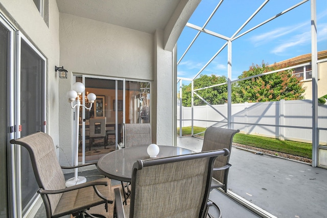 sunroom / solarium with a notable chandelier