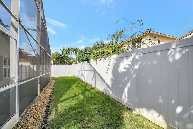 view of yard with glass enclosure