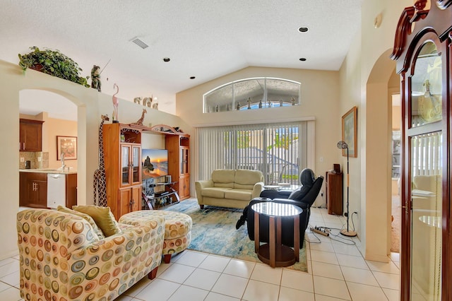 tiled living room with lofted ceiling, sink, and a textured ceiling