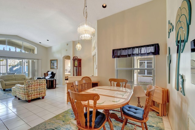 tiled dining room featuring lofted ceiling and a notable chandelier