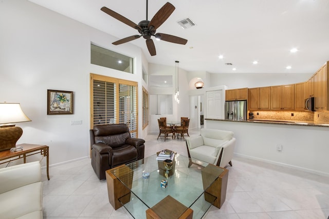 living room with light tile patterned flooring, ceiling fan, and high vaulted ceiling