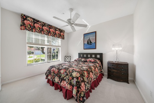 bedroom featuring ceiling fan and light colored carpet