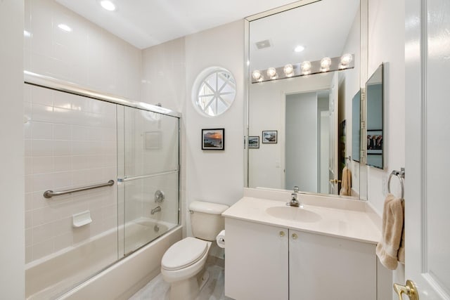 full bathroom with vanity, combined bath / shower with glass door, and toilet