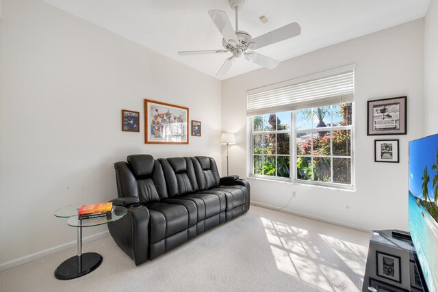 carpeted living room with ceiling fan