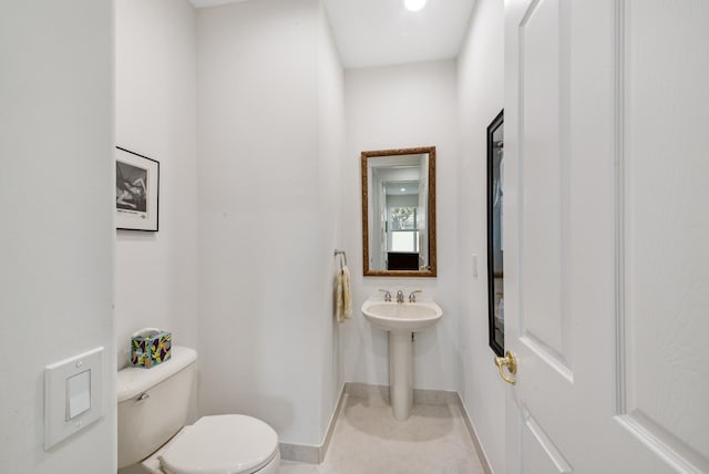 bathroom with sink, tile patterned floors, and toilet