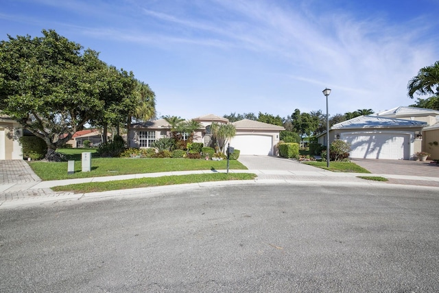 ranch-style home with a garage and a front lawn