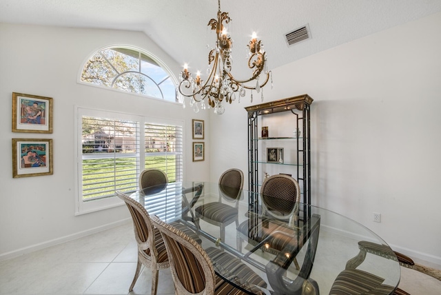 dining space with light tile patterned flooring, lofted ceiling, a healthy amount of sunlight, and a notable chandelier