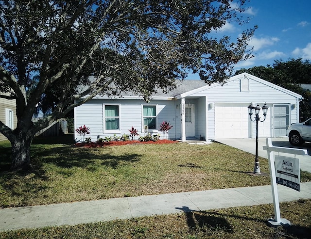 single story home with a garage and a front lawn