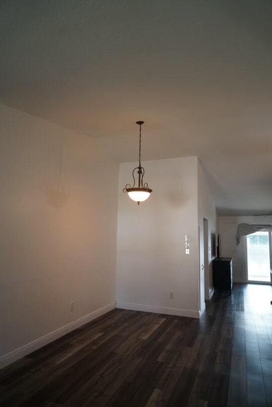 unfurnished room featuring dark hardwood / wood-style flooring