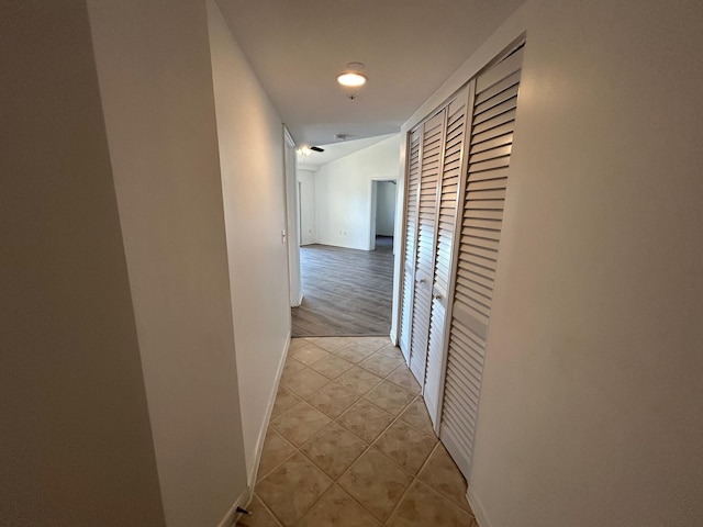 hall featuring light tile patterned floors