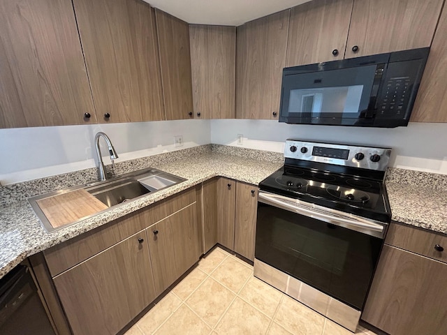 kitchen with light tile patterned floors, sink, and black appliances