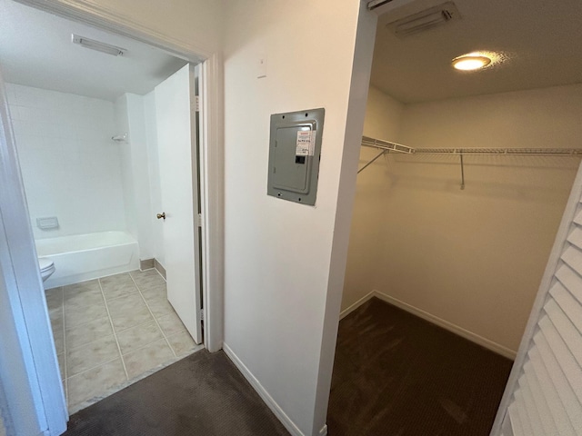 walk in closet featuring light tile patterned floors and electric panel