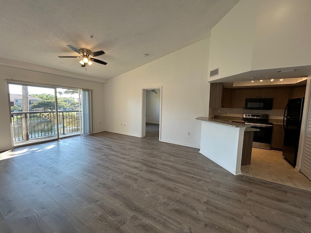 unfurnished living room with sink, high vaulted ceiling, a textured ceiling, dark hardwood / wood-style floors, and ceiling fan