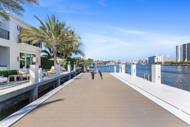 dock area featuring a water view and a city view