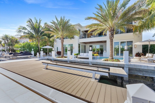 rear view of house featuring an outdoor hangout area and stucco siding