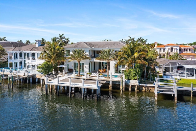 dock area featuring a water view, boat lift, and a residential view