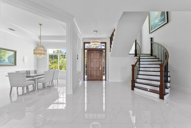 entrance foyer with a chandelier, stairs, marble finish floor, baseboards, and visible vents