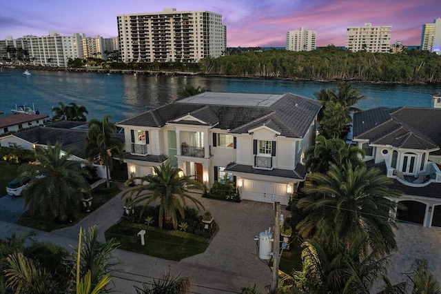 birds eye view of property featuring a city view and a water view