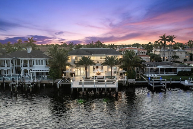 dock area with a water view and boat lift