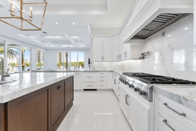 kitchen with stainless steel gas cooktop, custom exhaust hood, white cabinets, tasteful backsplash, and light stone counters