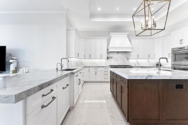 kitchen featuring a sink, white cabinetry, marble finish floor, and custom exhaust hood