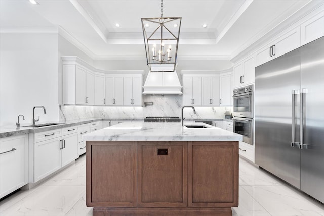 kitchen featuring appliances with stainless steel finishes, white cabinetry, and a sink