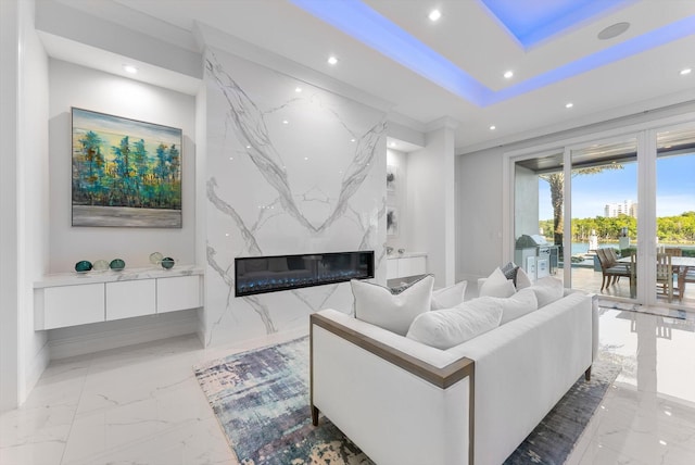 living room featuring a premium fireplace, an accent wall, recessed lighting, and marble finish floor