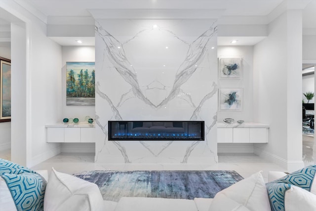 bathroom with marble finish floor, vanity, baseboards, and a premium fireplace