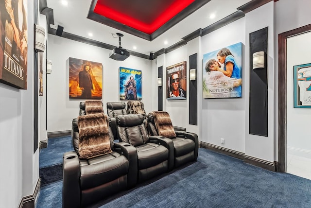 home theater room with a raised ceiling, recessed lighting, baseboards, and dark carpet