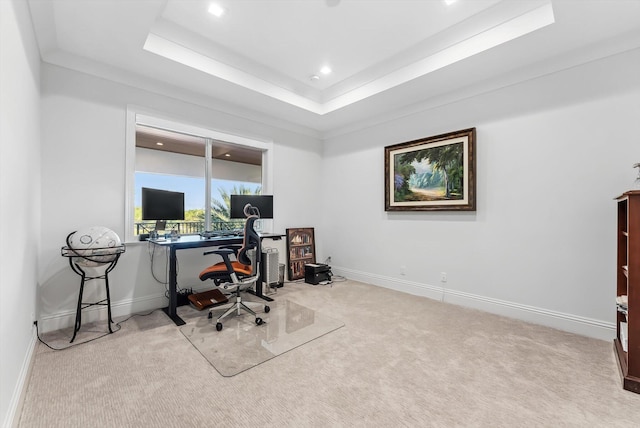 home office featuring light colored carpet, a raised ceiling, recessed lighting, and baseboards